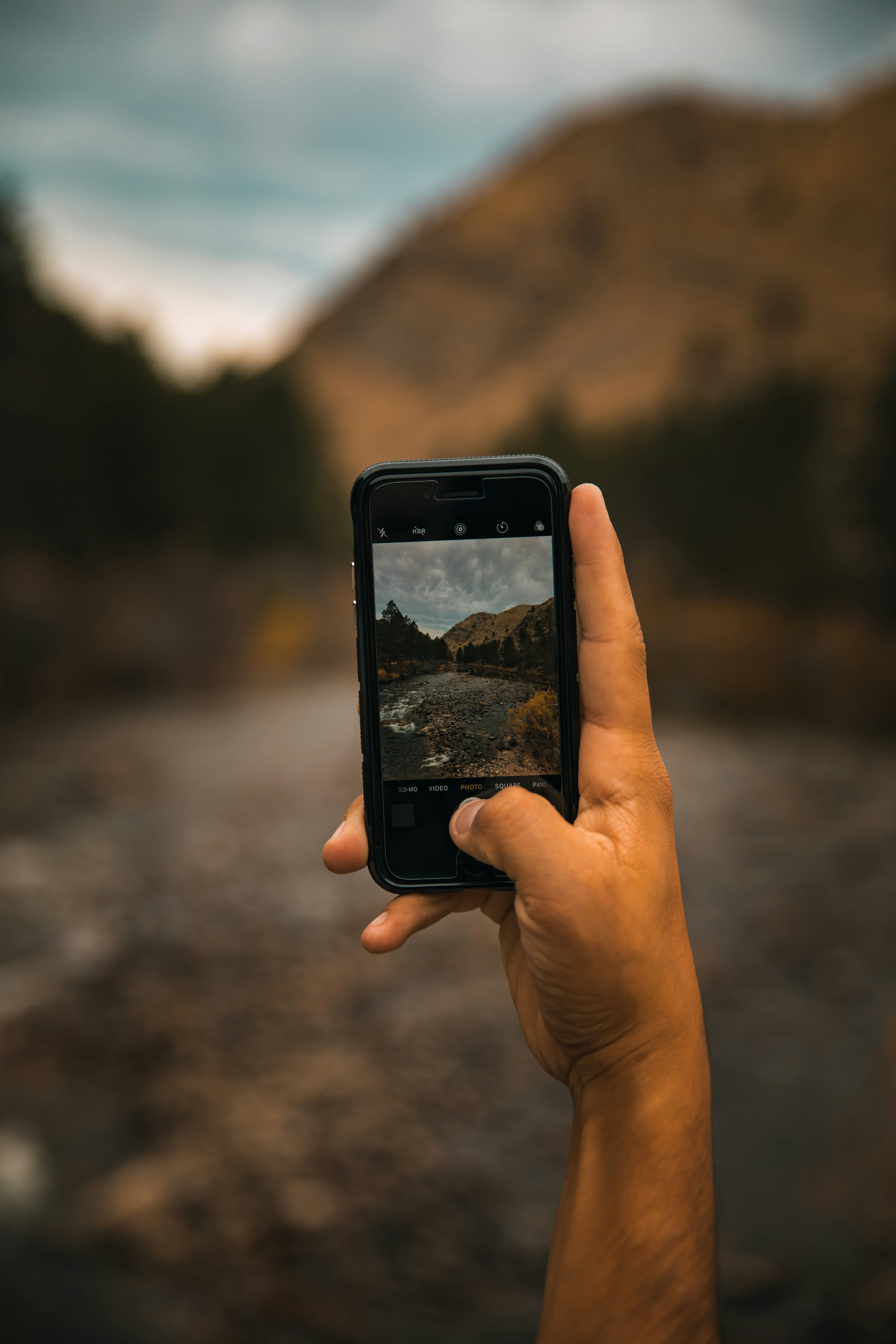 person taking photo of mountain